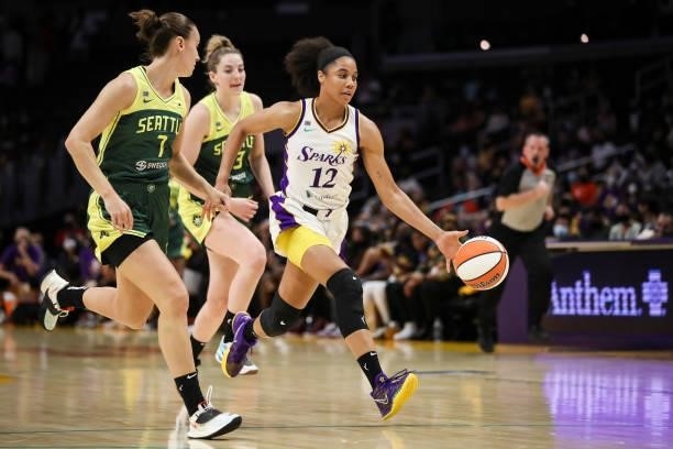 Forward Nia Coffey of the Los Angeles Sparks moves the ball down the court defended by forward Stephanie Talbot of the Seattle Storm in the first...