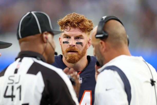 Andy Dalton and head coach Matt Nagy of the Chicago Bears speak with side judge Boris Cheek during the first half against the Los Angeles Rams at...