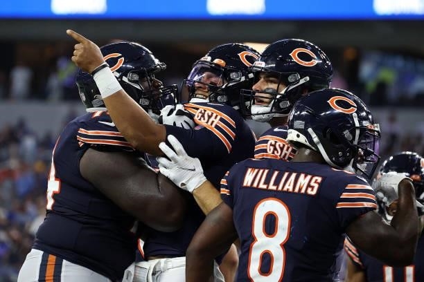 Justin Fields of the Chicago Bears celebrates a touchdown with teammates during the second half against the Los Angeles Rams at SoFi Stadium on...