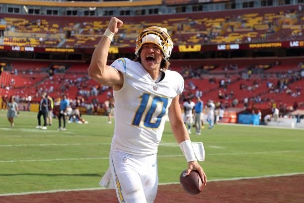 Quarterback Justin Herbert of the Los Angeles Chargers celebrates while leaving the field following the Chargers win over the Washington Football...