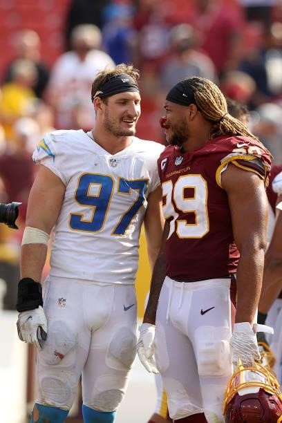 Defensive end Joey Bosa of the Los Angeles Chargers and defensive end Chase Young of the Washington Football Team talk following their game at...