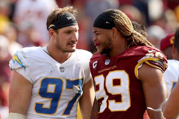 Defensive end Joey Bosa of the Los Angeles Chargers and defensive end Chase Young of the Washington Football Team talk following their game at...