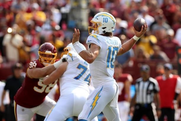 Quarterback Justin Herbert of the Los Angeles Chargers throws a pass against the Washington Football Team at FedExField on September 12, 2021 in...