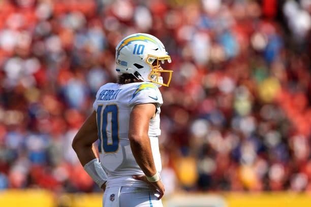 Quarterback Justin Herbert of the Los Angeles Chargers looks on in the second half against the Washington Football Team at FedExField on September...