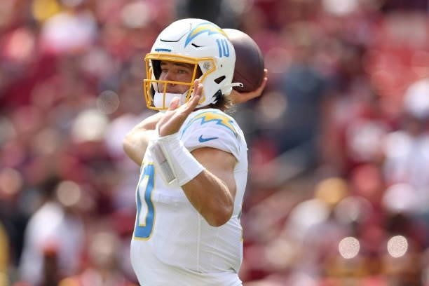 Quarterback Justin Herbert of the Los Angeles Chargers throws a pass against the Washington Football Team at FedExField on September 12, 2021 in...