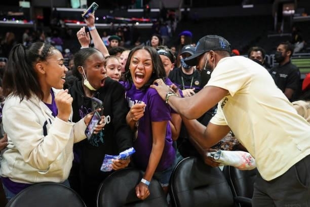 Player Chris Paul of the Phoenix Suns signs a fan's shirt after the game between the Los Angeles Sparks and the Seattle Storm at Staples Center on...