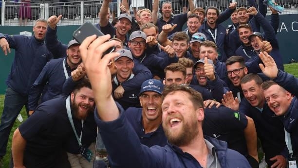 Billy Horschel of the United States of America poses with the trophy and with greenkeeping staff after winning The BMW PGA Championship at Wentworth...
