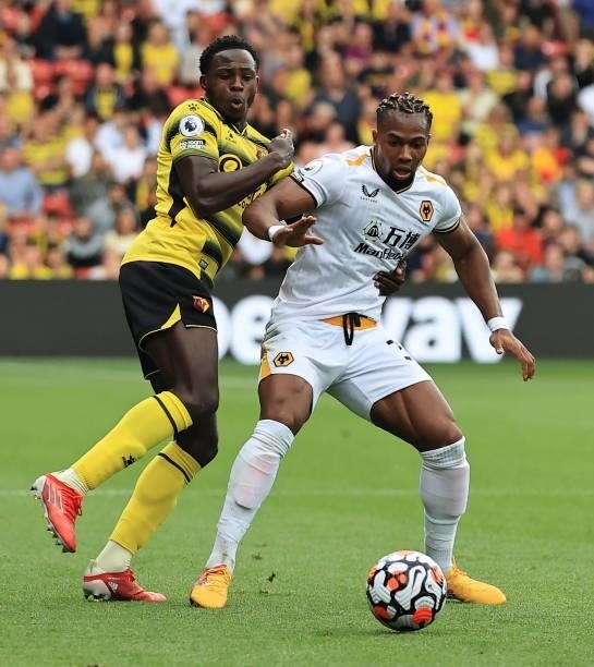 Adama Traore of Wolverhampton Wanderers is challenged by Jeremy Nkagia during the Premier League match between Watford and Wolverhampton Wanderers at...