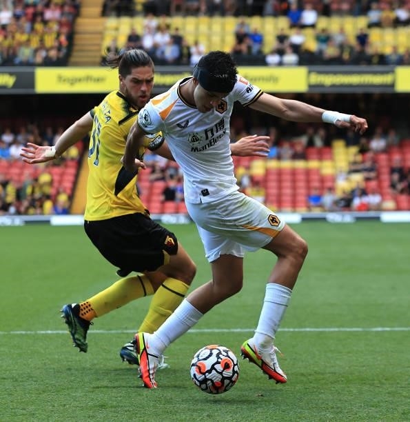 Raul Jimenez of Wolverhampton Wanderers controls the ball watched by Francisco Sierralta during the Premier League match between Watford and...