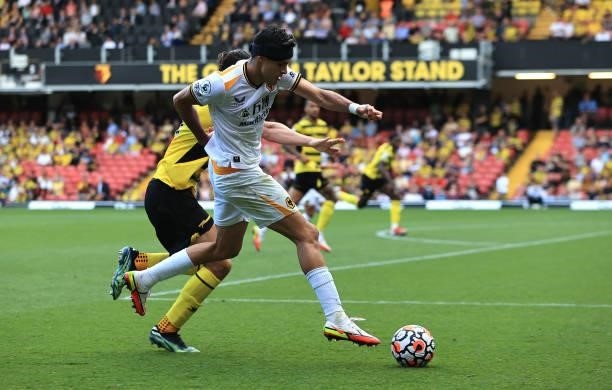 Raul Jimenez of Wolverhampton Wanderers controls the ball watched by Francisco Sierralta during the Premier League match between Watford and...