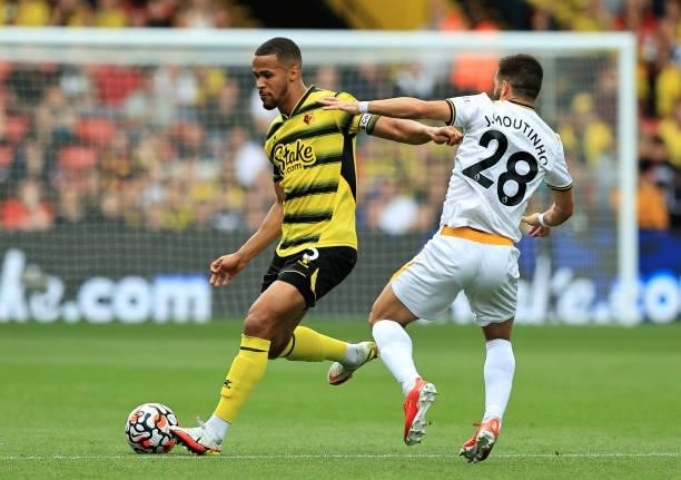 William Troost-Ekong of Watford passes the ball as Joao Moutinho challenges during the Premier League match between Watford and Wolverhampton...