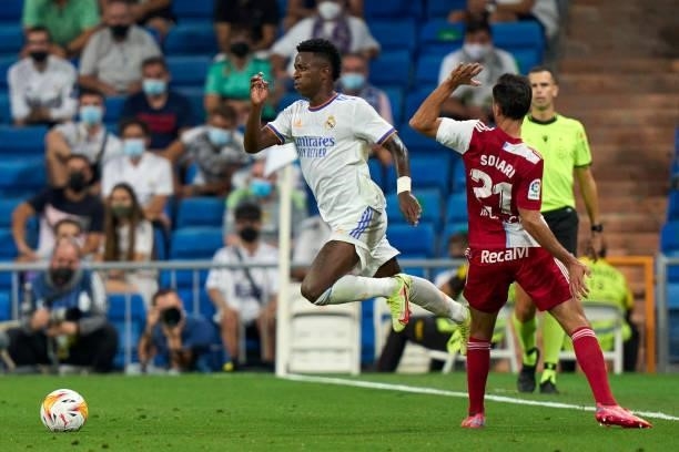 Vinicius Junior of Real Madrid battle for the ball with Augusto Solari of RC Celta during the La Liga Santader match between Real Madrid CF and RC...