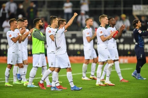 Players of Moenchengladbach applaud to their fans after the Bundesliga match between Borussia Mönchengladbach and DSC Arminia Bielefeld at...