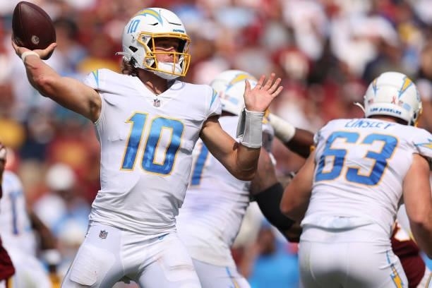 Justin Herbert of the Los Angeles Chargers makes a pass against the Washington Football Team at FedExField on September 12, 2021 in Landover,...