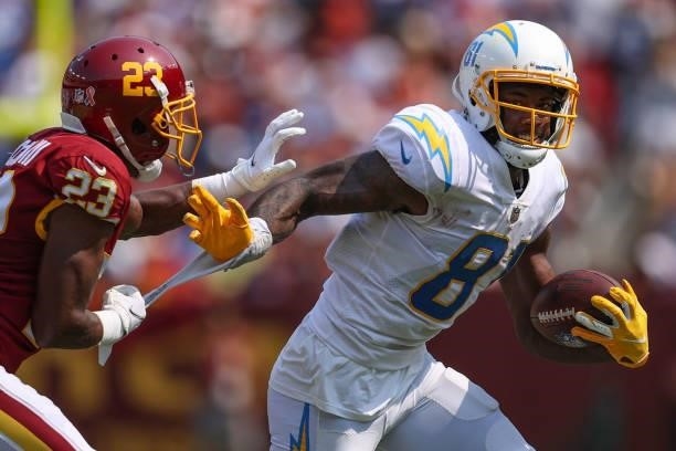Mike Williams of the Los Angeles Chargers rushes past William Jackson of the Washington Football Team during the second quarter at FedExField on...