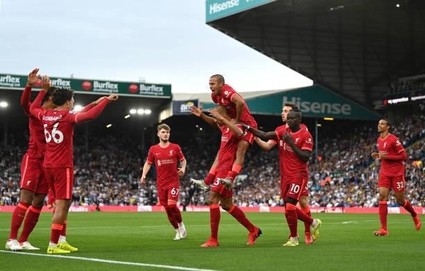 Thiago Alcantara of Liverpool and team mates congratulate Fabinho during the Premier League match between Leeds United and Liverpool at Elland Road...