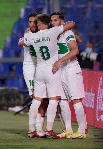 Lucas Perez of Elche celebrates after scoring his team's first goal with his teammates during the La Liga Santander match between Getafe CF and Elche...