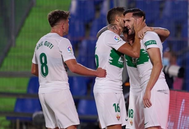 Lucas Perez of Elche celebrates after scoring his team's first goal with his teammates during the La Liga Santander match between Getafe CF and Elche...