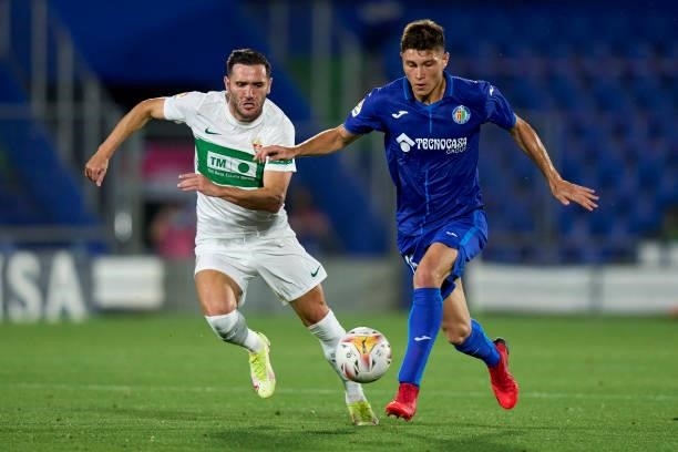 Jorge Cuenca of Getafe CF battle for the ball with Lucas Perez of Elche CF during the La Liga Santander match between Getafe CF and Elche CF at...