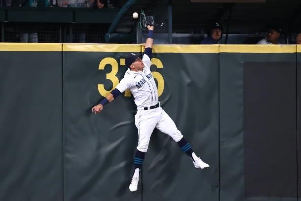 Dylan Moore of the Seattle Mariners is unable to make the catch off a home run by Jose Iglesias of the Boston Red Sox during the third inning at...