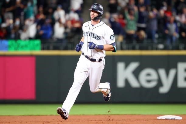 Mitch Haniger of the Seattle Mariners laps the bases after hitting a three-run home run against the Boston Red Sox to take a 5-3 lead in the seventh...