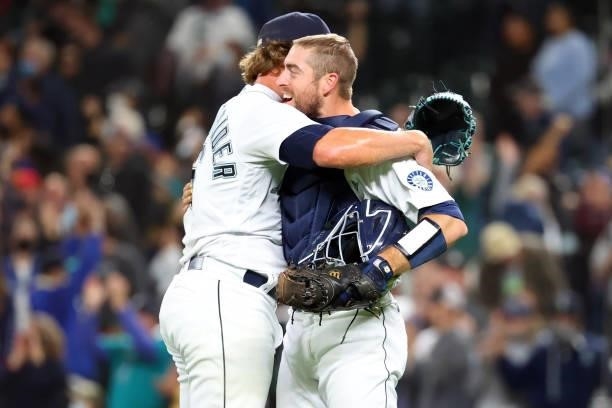 Drew Steckenrider and Tom Murphy of the Seattle Mariners hug after defeating the Boston Red Sox 5-4 at T-Mobile Park on September 13, 2021 in...