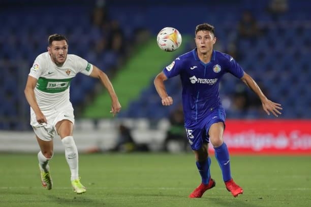 Jorge Cuenca of Getafe CF competes for the ball with Lucas Perez of Elche CF during the La Liga Santander match between Getafe CF and Elche CF at...