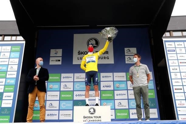 João Almeida of Portugal and Team Deceuninck - Quick-Step celebrates winning the yellow leader jersey on the podium ceremony after the 81st...