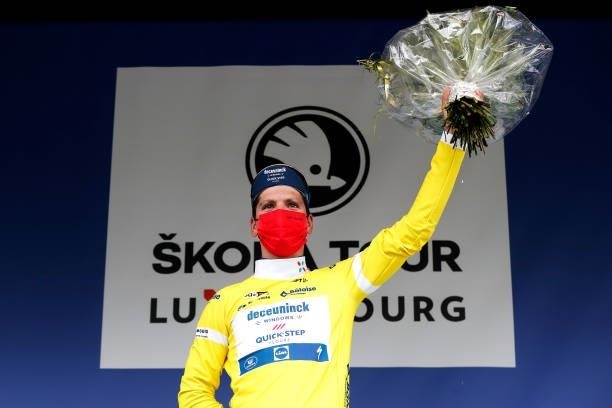 João Almeida of Portugal and Team Deceuninck - Quick-Step celebrates winning the yellow leader jersey on the podium ceremony after the 81st...