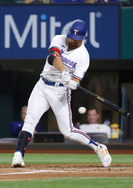 Nathaniel Lowe of the Texas Rangers singles against the Houston Astros during the first inning at Globe Life Field on September 13, 2021 in...