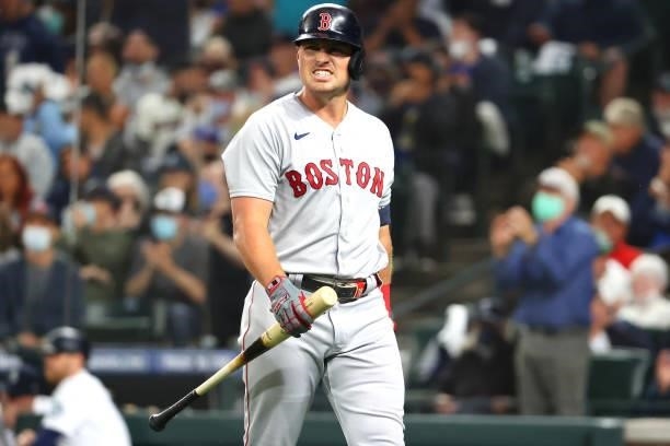 Hunter Renfroe of the Boston Red Sox reacts after striking out while swinging against the Seattle Mariners to end the top of the second inning at...