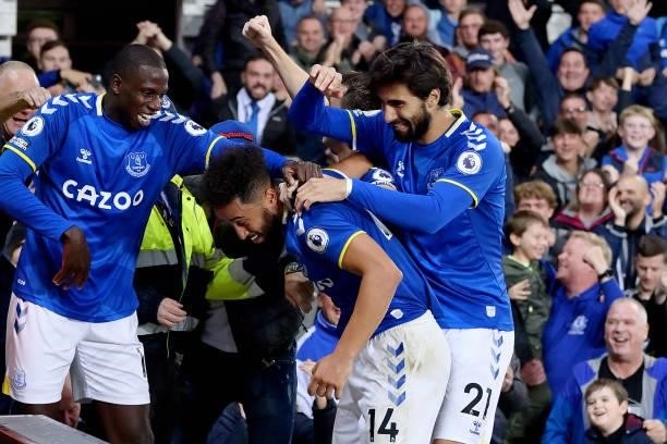Andros Townsend of Everton celebrates his goal with Abdoulaye Doucoure and Andre Gomes during the Premier League match between Everton and Burnley at...