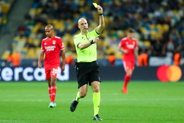 Referee Anthony Taylor shows a yellow card during the UEFA Champions League match between FC Dynamo Kiev and SL Benfica at NSC Olimpiyskyi on...