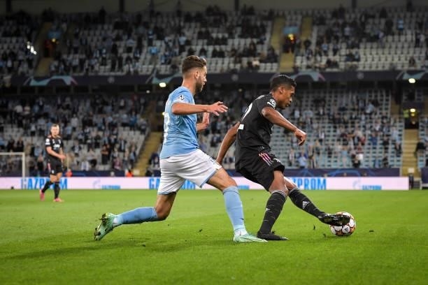 Alex Sandro of Juventus in action against Lasse Nielsen of Malmo during the UEFA Champions League group H match between Malmo FF and Juventus at...