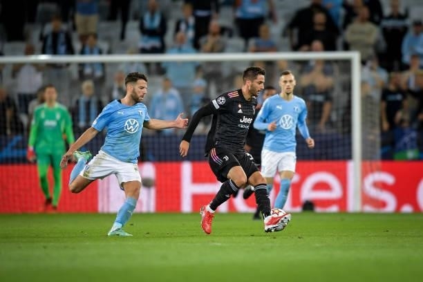 Rodrigo Bentancur of Juventus battle for the ball with Lasse Nielsen of Malmo during the UEFA Champions League group H match between Malmo FF and...