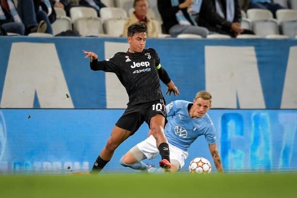 Paulo Dybala of Juventus and Soeren Rieks of Malmo battle for the ball during the UEFA Champions League group H match between Malmo FF and Juventus...