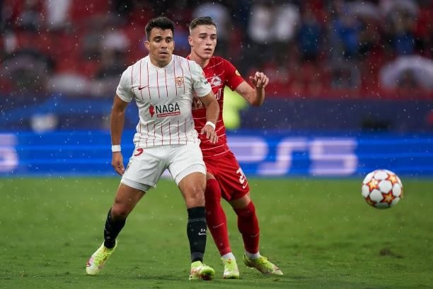 Marcos Acuna of Sevilla FC competes for the ball with Luka Sucic of RB Salzburg during the UEFA Champions League group G match between Sevilla FC and...