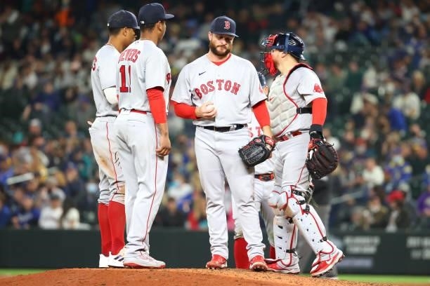 Ryan Brasier of the Boston Red Sox reacts as manager Alex Cora comes to remove him from the game against the Seattle Mariners during the seventh...
