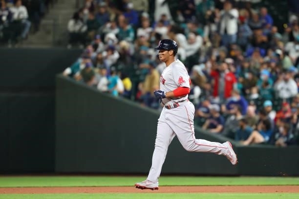 Rafael Devers of the Boston Red Sox laps the bases after hitting a solo home run against the Seattle Mariners in the eighth inning at T-Mobile Park...