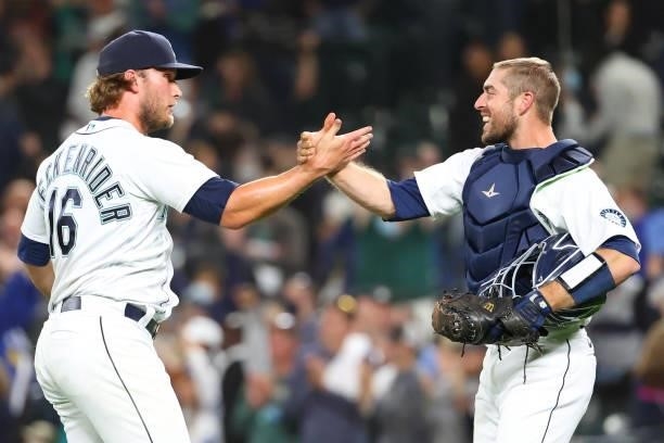 Drew Steckenrider and Tom Murphy of the Seattle Mariners embrace after defeating the Boston Red Sox 5-4 at T-Mobile Park on September 13, 2021 in...