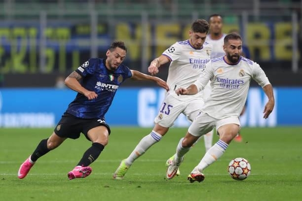 Hakan Calhanoglu of FC Internazionale attempts to take on Federico Valverde and Daniel Carvajal of Real Madrid during the UEFA Champions League group...