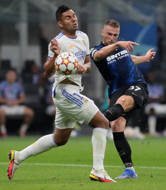 Milan Skriniar of FC Internazionale battles for possession with Casemiro of Real Madrid during the UEFA Champions League group D match between Inter...