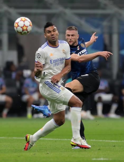 Milan Skriniar of FC Internazionale battles for possession with Casemiro of Real Madrid during the UEFA Champions League group D match between Inter...