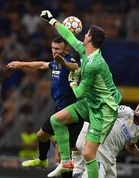 Ivan Perisic of FC Internazionale competes for the ball with Thibaut Courtois of Real Madrid during the UEFA Champions League group D match between...