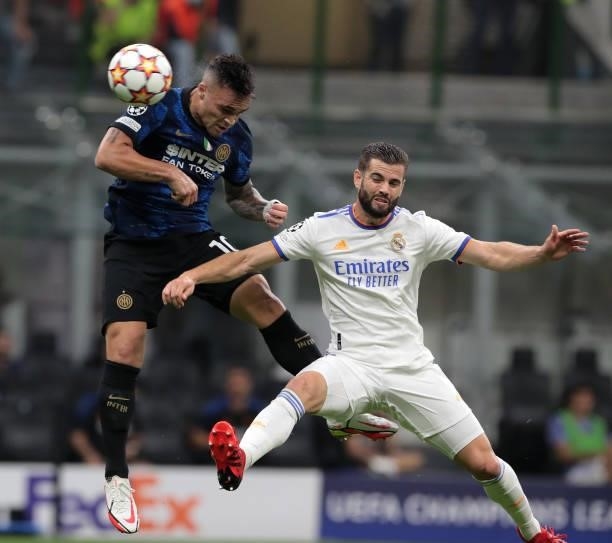Lautaro Martinez of FC Internazionale battles for possession with Nacho Fernández of Real Madrid during the UEFA Champions League group D match...