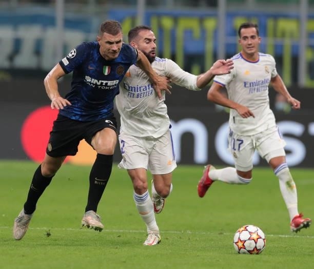 Edin Dzeko of FC Internazionale is challenged by Daniel Carvajal of FC Internazionale during the UEFA Champions League group D match between Inter...