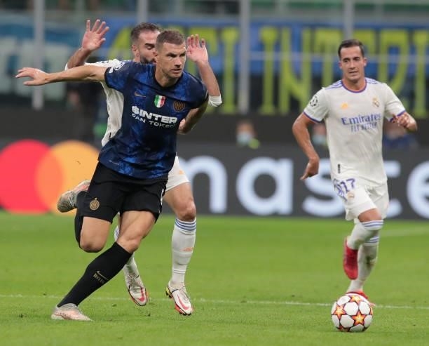 Edin Dzeko of FC Internazionale is challenged by Daniel Carvajal of FC Internazionale during the UEFA Champions League group D match between Inter...