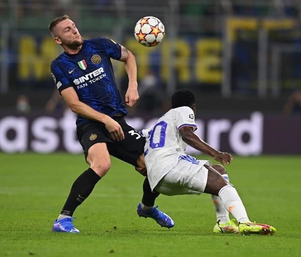 Milan Skriniar of FC Internazionale competes for the ball with Vinicius Junior of Real Madrid during the UEFA Champions League group D match between...