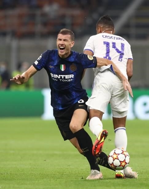 Edin Dzeko of FC Internazionale clashes with Casemiro of Real Madrid during the UEFA Champions League group D match between Inter and Real Madrid at...