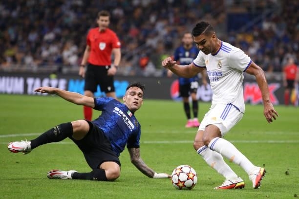 Lautaro Martinez of FC Internazionale slides in to challenge Casemiro of Real Madrid during the UEFA Champions League group D match between Inter and...
